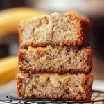 Freshly sliced banana bread on a rustic board