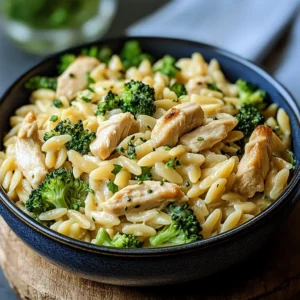 Cheesy Chicken Broccoli Orzo in a bowl on rustic table