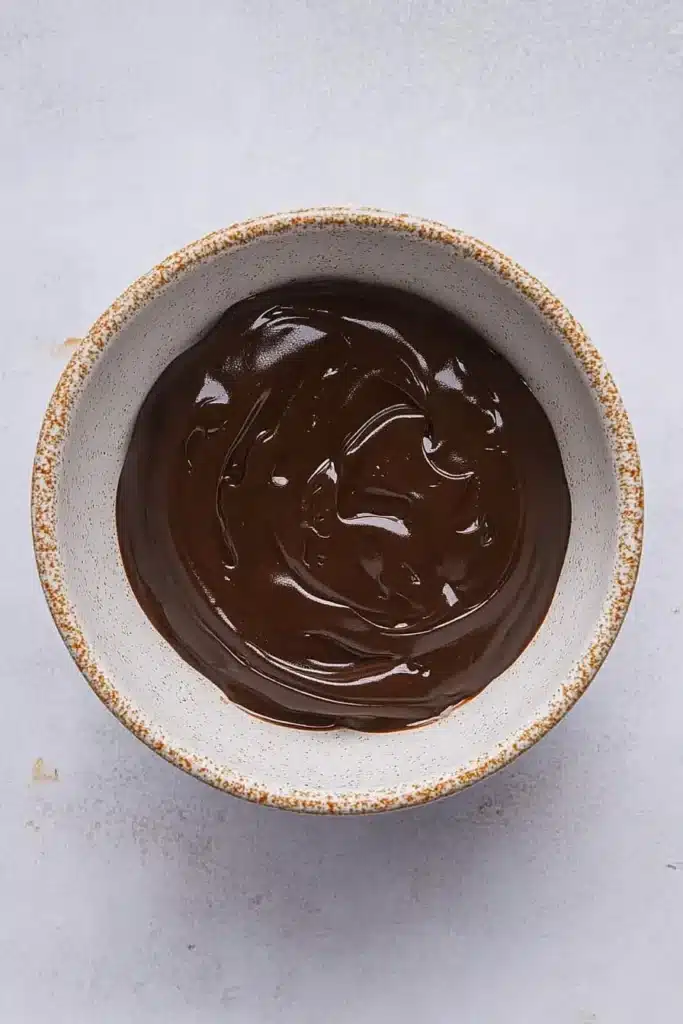 Dubai Chocolate Strawberries: The Sweetest Fusion You’ll Ever Taste 10 Mixing chocolate and pistachio cream for dessert dip