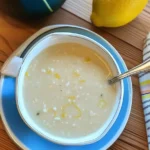 Greek Lemon Rice Soup: A Zesty Bowl of Comfort That Tastes Like Home 6 Greek Lemon Rice Soup in ceramic bowl on rustic table with lemon garnish