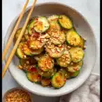 Peanut Chili Crisp Cucumber Salad That Packs a Punch 13 Overhead view of peanut chili crisp cucumber salad in rustic bowl